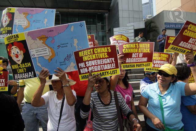 'IT'S OURS.' Party-list group Akbayan stages a rally in front of the Chinese consulate in Makati City on March 3, 2014 to protest the so-called water cannon incident involving Chinese government ships in the disputed West Philippine Sea (South China Sea). Photo by Jose Del/Rappler
