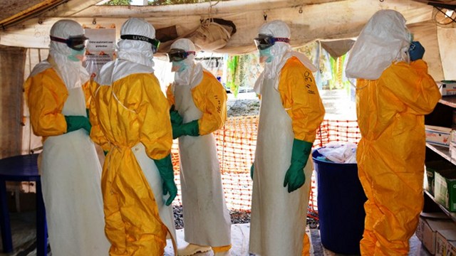 WHITE COATS? Guinea's health workers wearing protective suits join members of the Medecins Sans Frontieres Ebola treatement centre near the main Donka hospital in Conakry on September 25, 2014. Poto by Cellou Binani/AFP 