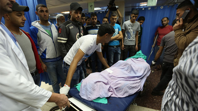 TEEN MANHUNT FATALITIES. The body of 26-year-old Ahmed Abu Shino, who was allegedly killed by Israeli soldiers at Al Ein Refugee Camp, is brought to Rafedya Hospital Morgue near Nablus, the West Bank, on June 22, 2014. Photo by Alaa Badarneh/EPA