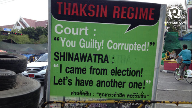 SEEING RED. An anti-Thaksin sign greets passers-by at the entrance to one of the protests sites in Bangkok