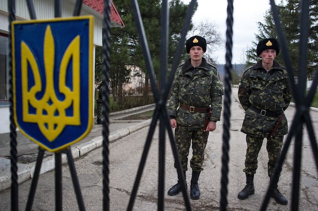 ON GUARD. Ukrainian military stand inside the territory of a Ukrainian military unit in the village of Perevalnoye, outside Simferopol, Ukraine, 02 March 2014. Alexey Furman/EPA
