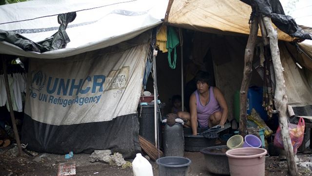 MAJOR GAP. Permanent shelter remains a primary challenge a year after Yolanda, with some families still living in tent cities. October 14, 2014 photo by Noel Celis/AFP 