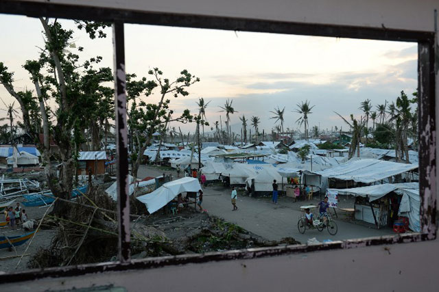 100 DAYS AFTER. Row of tents used as temporary shelters by resident-survivors of super Typhoon Yolanda (Haiyan) along the coastal area of Tacloban City. The United Nations warned on February 15 that millions of survivors of the Philippines' deadliest typhoon were still without adequate shelter 100 days after the disaster. Photo by Ted Aljibe/AFP